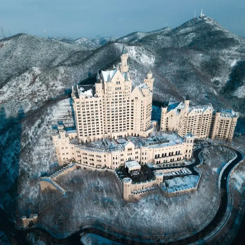 The Castle Hotel Dalian, a fairy-tale castle-style resort on a snow-covered hilltop overlooking the city