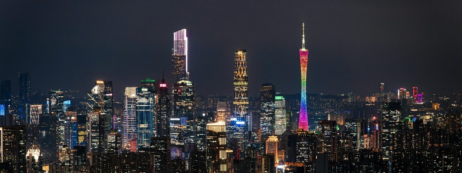 Guangzhou's Canton Tower and the Zhujiang New Town skyline reflected in the Pearl River at night