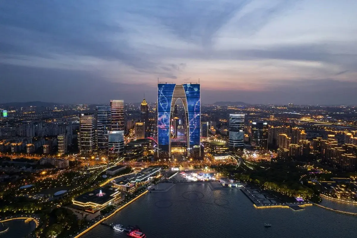 The Gate of the Orient tower and the Suzhou Industrial Park CBD skyline lit up at dusk
