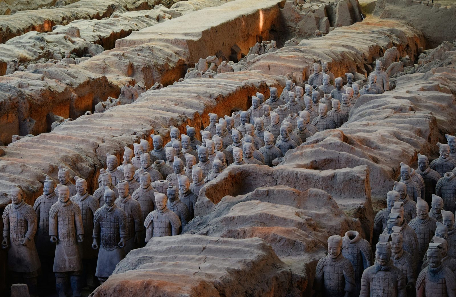 Rows of terracotta soldiers standing in the excavated earthen corridors of Pit 1