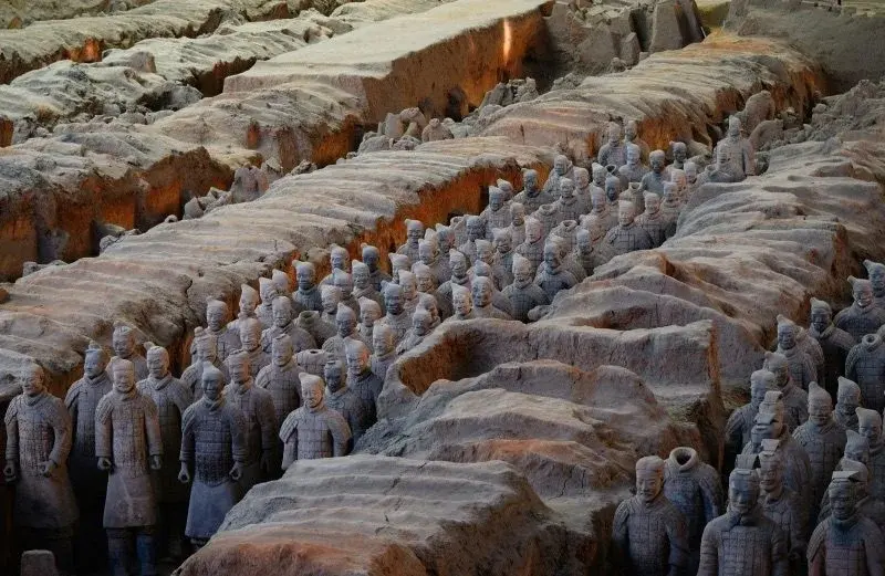 Rows of terracotta soldiers standing in the excavated earthen corridors of Pit 1