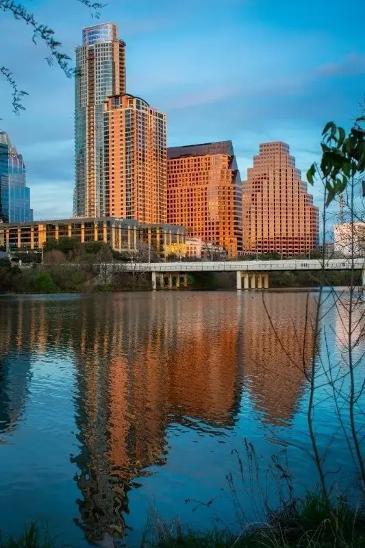 Austin's downtown high-rise towers reflected in Lady Bird Lake at dusk