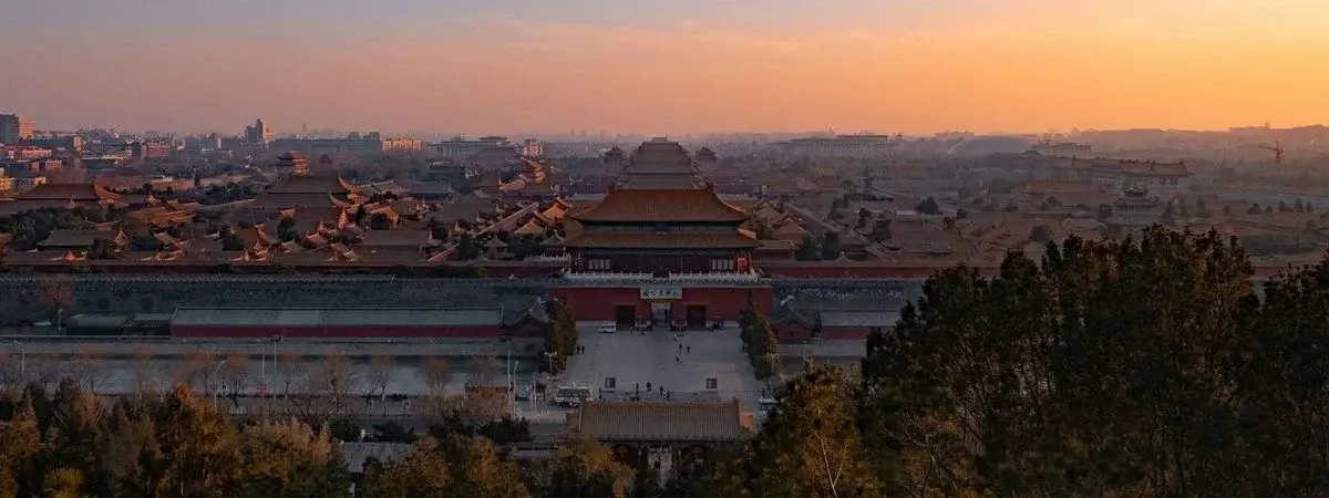 The Forbidden City's golden roofs stretching to the horizon at dusk