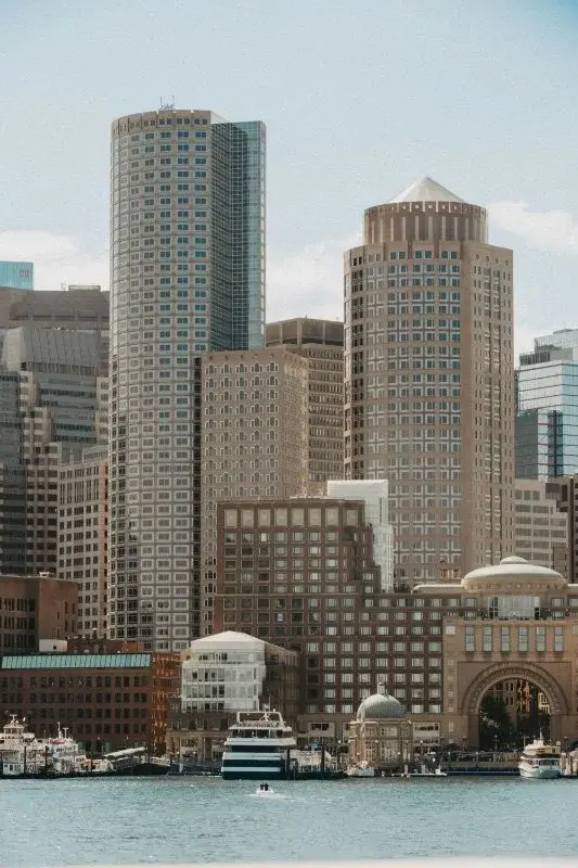 Boston's Financial District skyline seen across the harbor, with the Rowes Wharf rotunda in the foreground