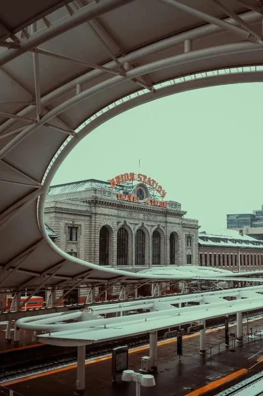 The historic facade of Denver's Union Station seen through a modern transit canopy