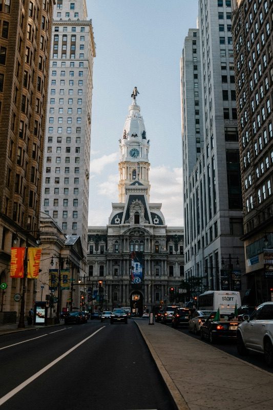 Philadelphia's City Hall clock tower viewed down a street canyon of office towers