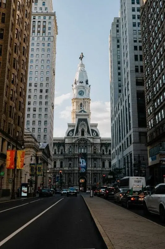 Philadelphia's City Hall clock tower viewed down a street canyon of office towers