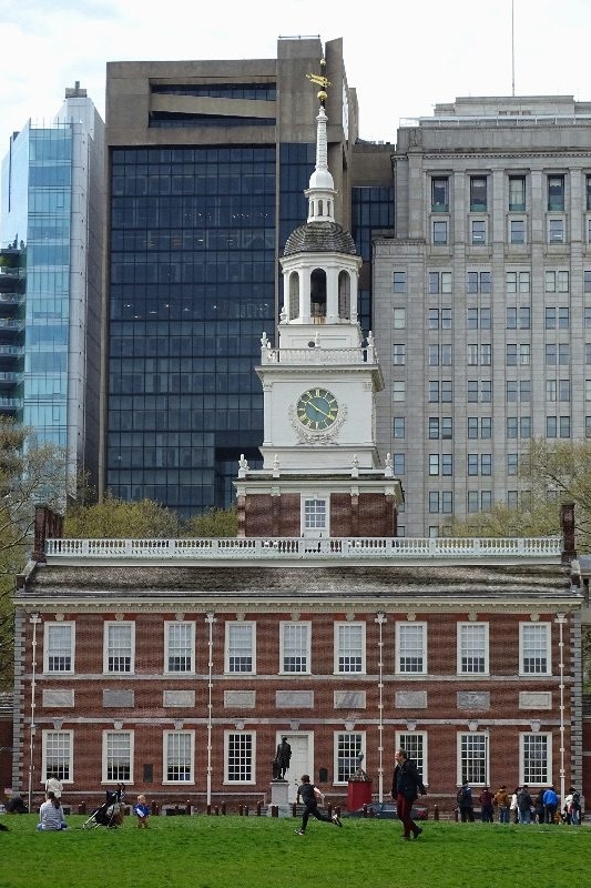 Independence Hall's white steeple against a backdrop of modern Philadelphia office towers