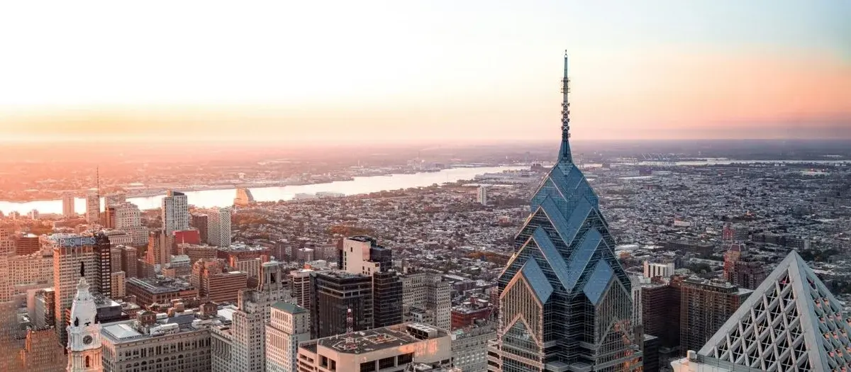 Philadelphia skyline at dusk, City Hall's clock tower and modern towers rising above the old city