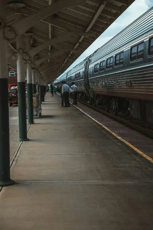 Passengers boarding an Amtrak train under the historic covered platform of Richmond's Main Street Station