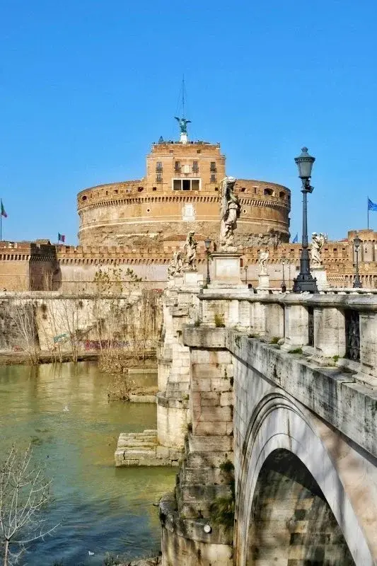 Castel Sant'Angelo seen across the Tiber, statue-lined Ponte Sant'Angelo in the foreground