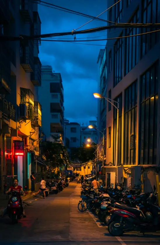 Sanya street scene with Northeast Chinese restaurant signs alongside Li minority patterns