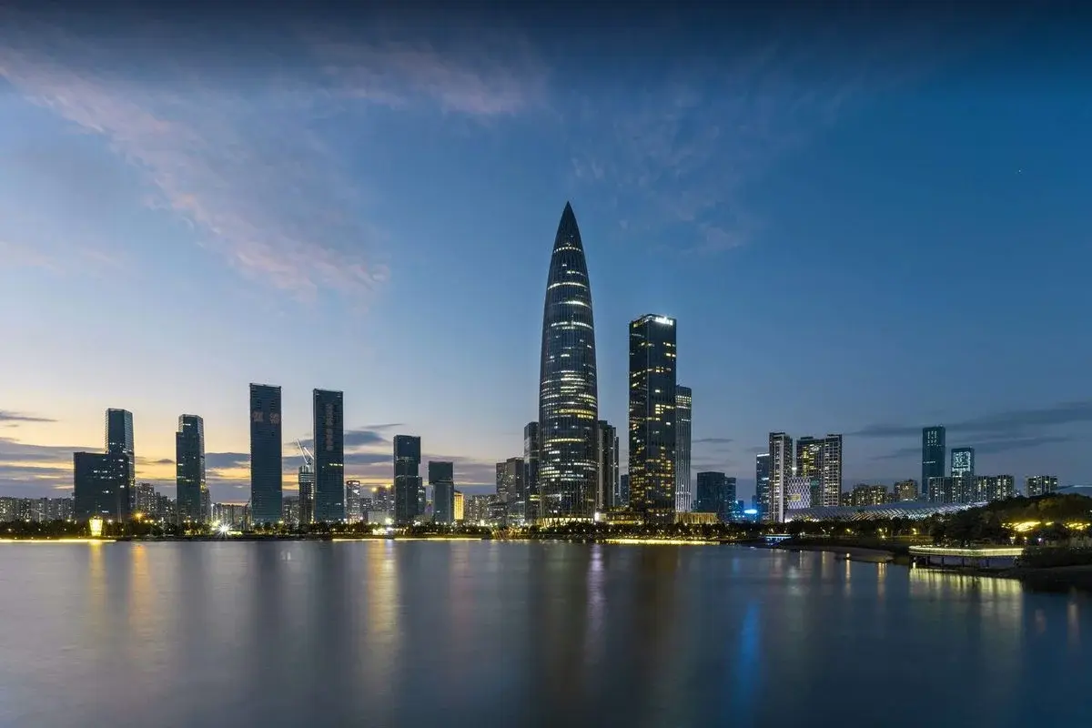 Shenzhen's Nanshan skyline at dusk over Shenzhen Bay, the tapering China Resources Tower at center