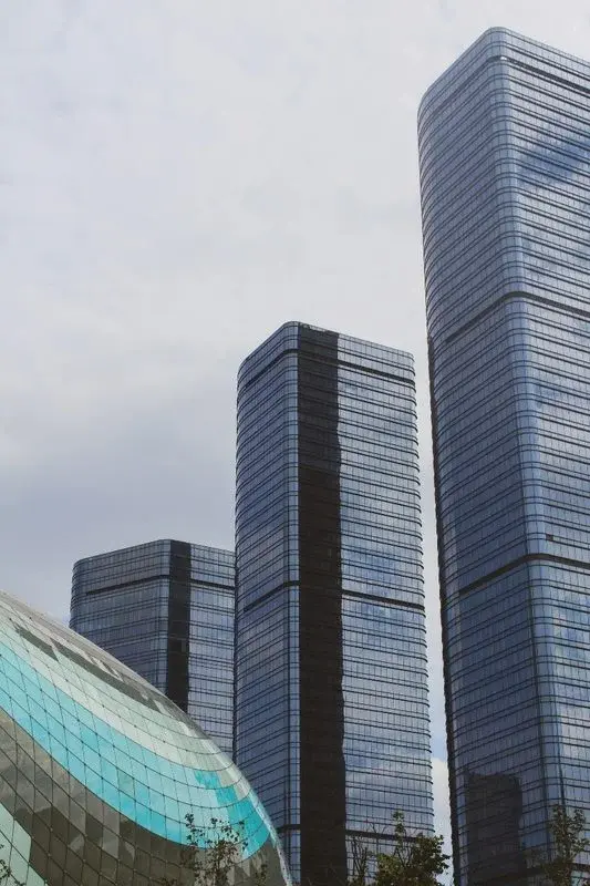 Suzhou's CBD glass skyscrapers rising behind the distinctive oval dome roof of Suzhou Center