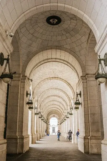 A vaulted stone arcade at Washington Union Station, hanging lanterns receding toward the vanishing point