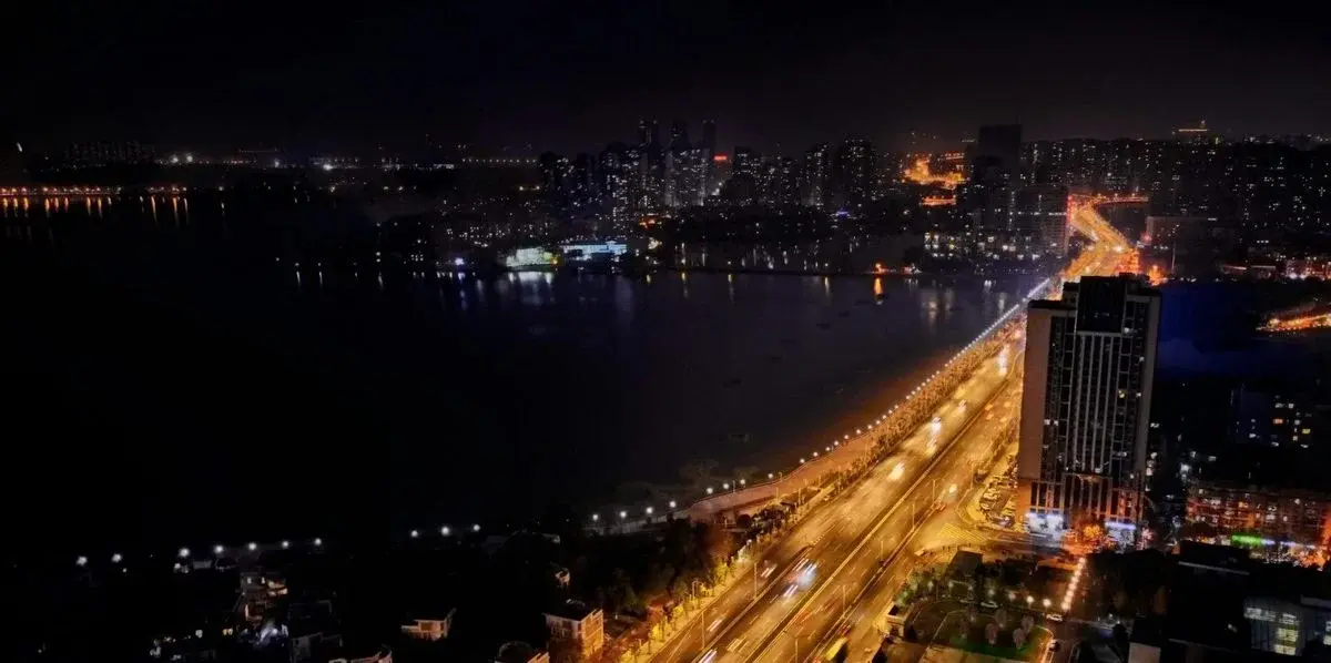 Wuhan skyline and the Yangtze River at dusk, city lights reflecting on the water