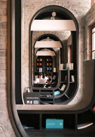A student reading in a brick-vaulted study space in Wuhan