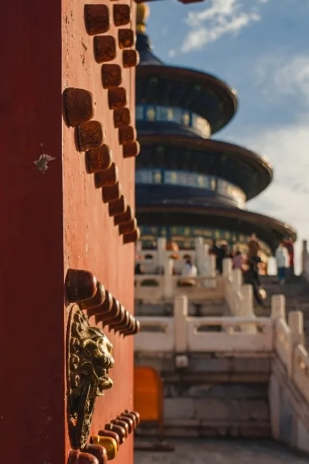 Red door of Beijing's Temple of Heaven with bronze door studs