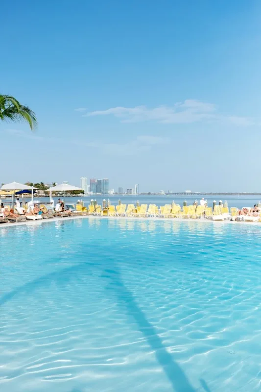 Miami poolside with loungers, representing the US paradise premium