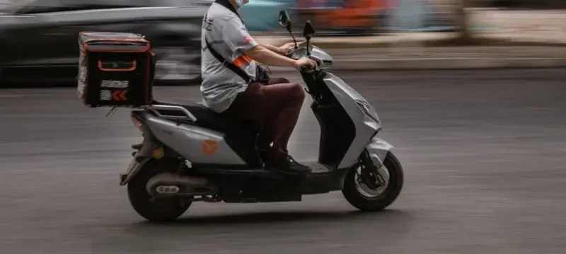 China delivery scooter with insulated box — instant retail and food delivery logistics in action