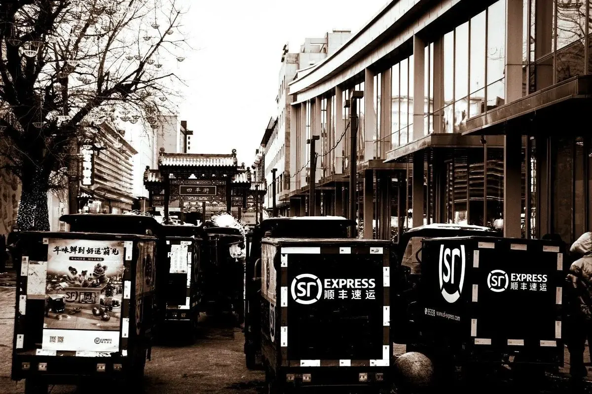 SF Express fleet parked on a Chinese city street — national delivery infrastructure