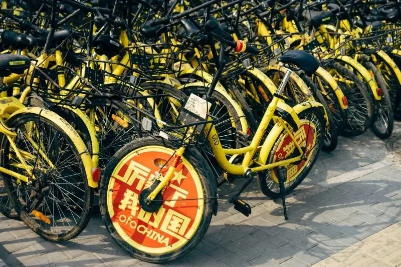 Close-up of an ofo shared bike wheel cover reading ofo CHINA and a Chinese slogan
